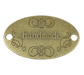 Nášivka Hand Made kovová - bronzová - 32x19 mm